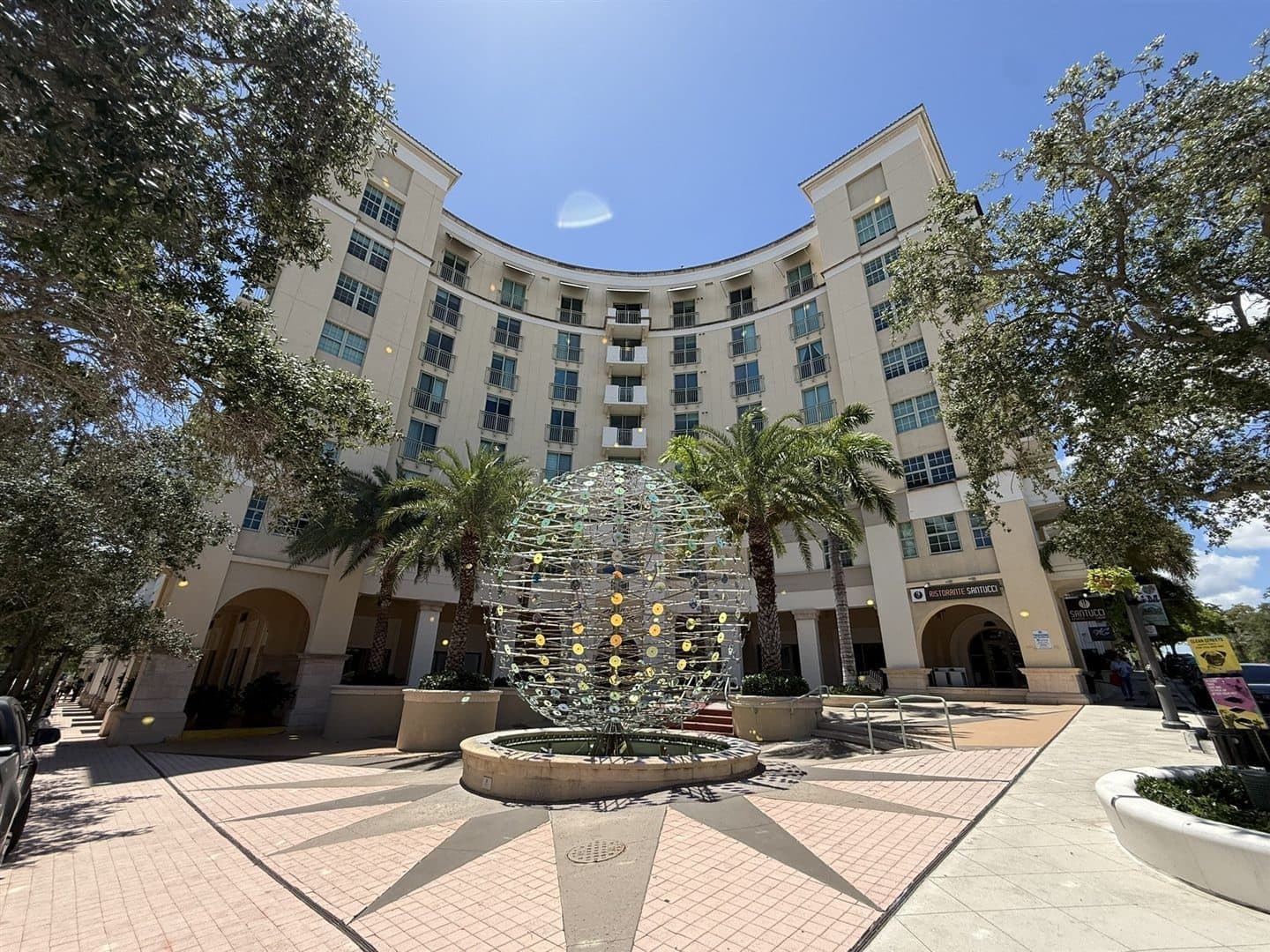 610 Clematis — The Building on Clematis Street — The crescent facade and sphere fountain from the Clematis Street plaza