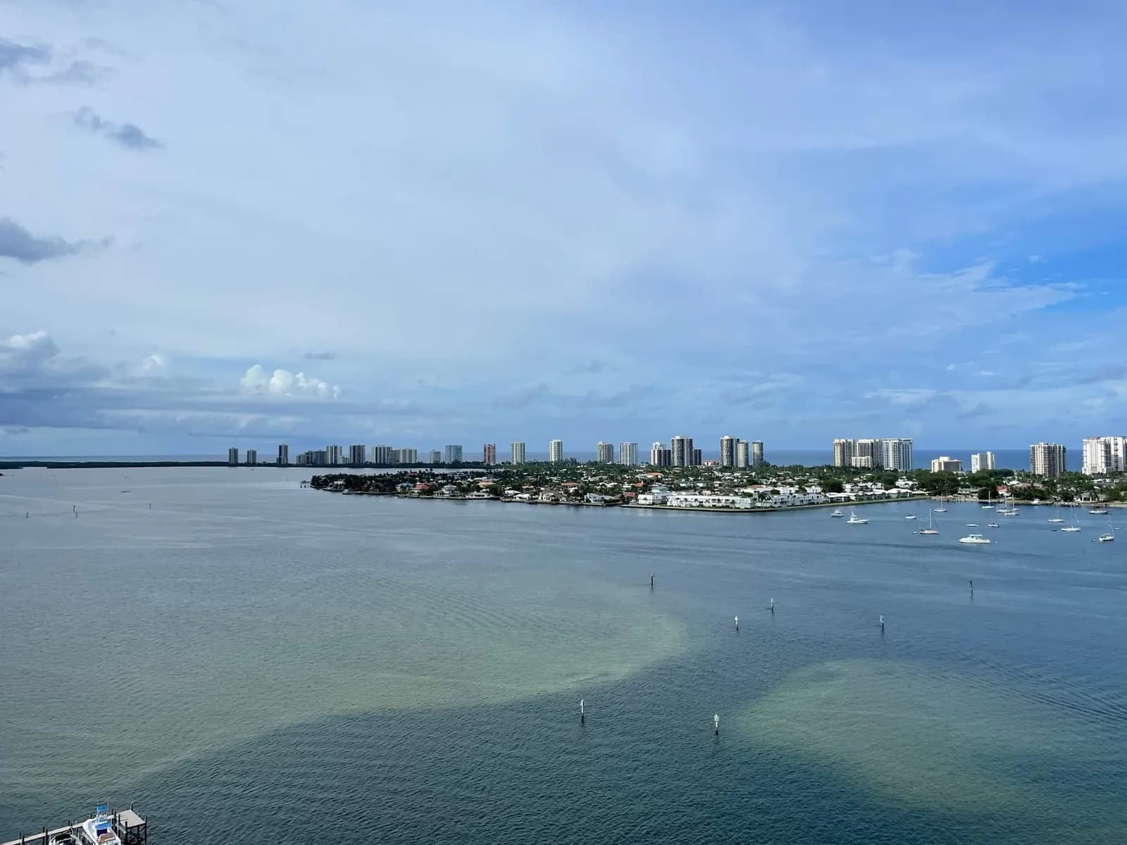 Singer Island seen across the Lake Worth Lagoon: lagoon-side homes in front, oceanfront towers behind