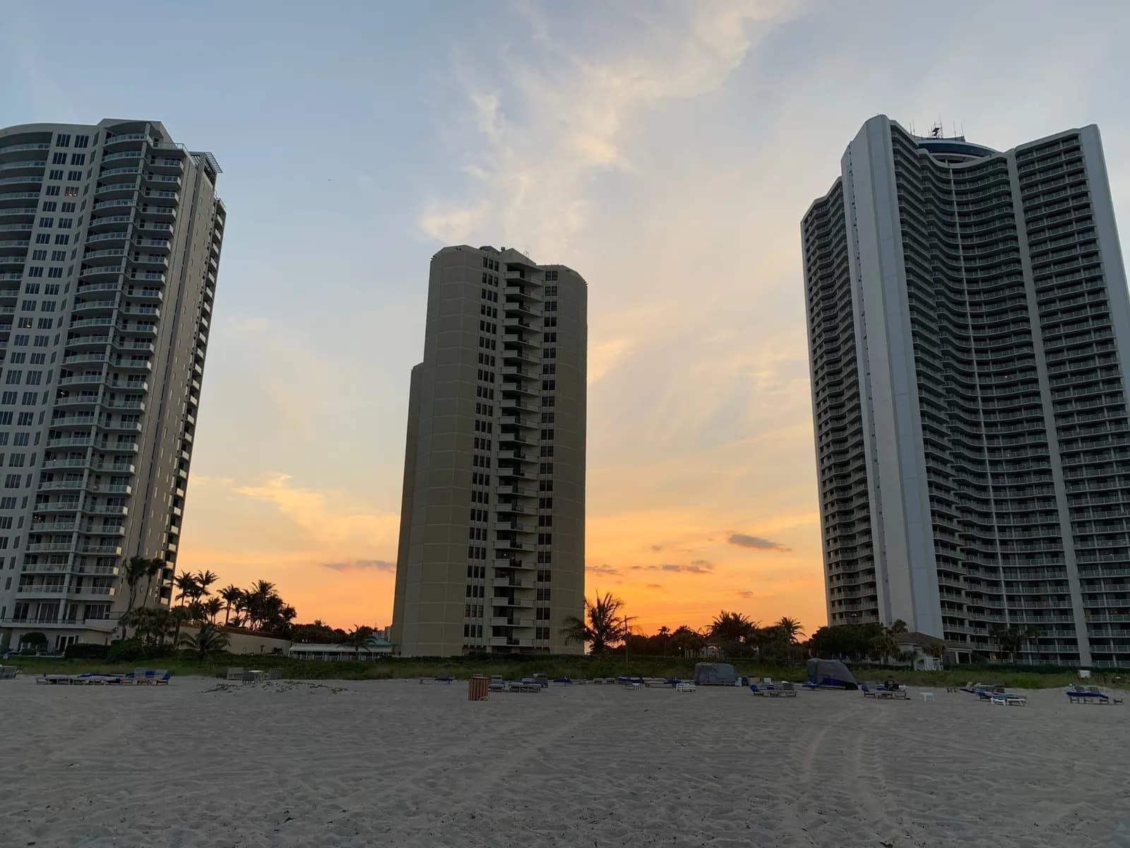 Tiara, right, and a neighboring tower seen from the beach at sunset