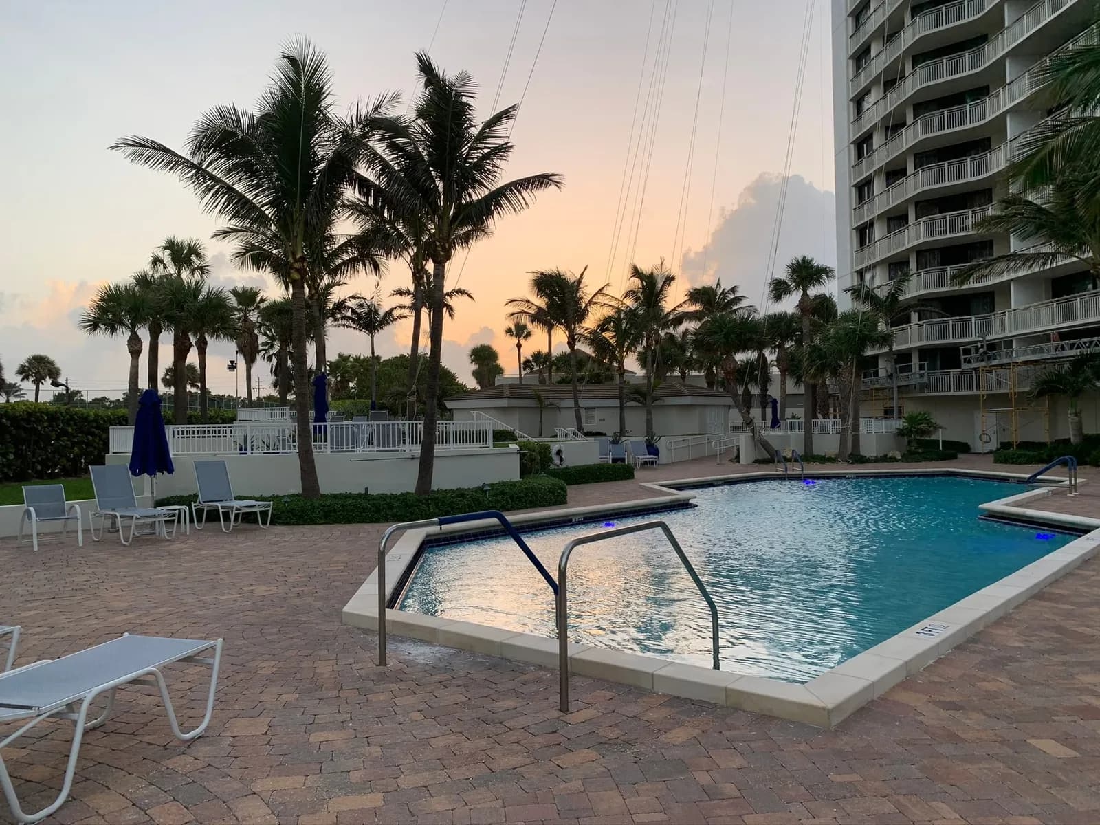 The Tiara pool deck at dusk, with palms, lounge chairs and the tower alongside