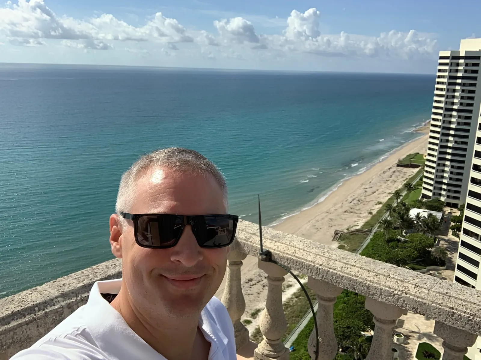 John Oliver of DO Homes Group on the Via Delfino roof, with the ocean and beach behind him