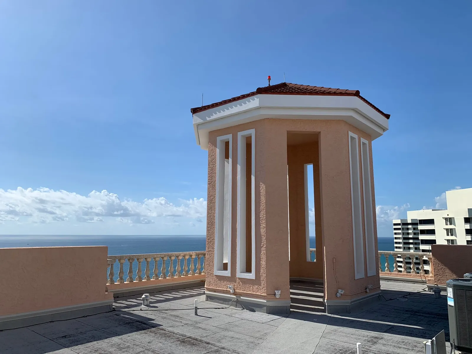 The red-tile cupola on the Via Delfino roof, with the Atlantic behind it