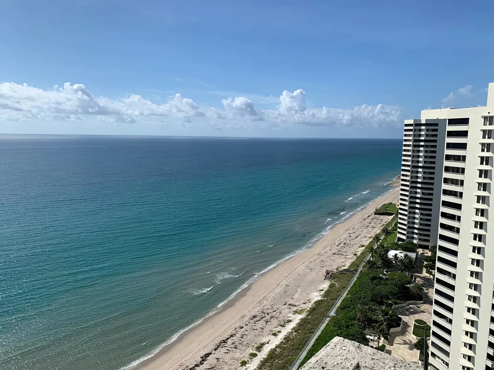 The ocean beach and neighboring towers seen from the Via Delfino roof