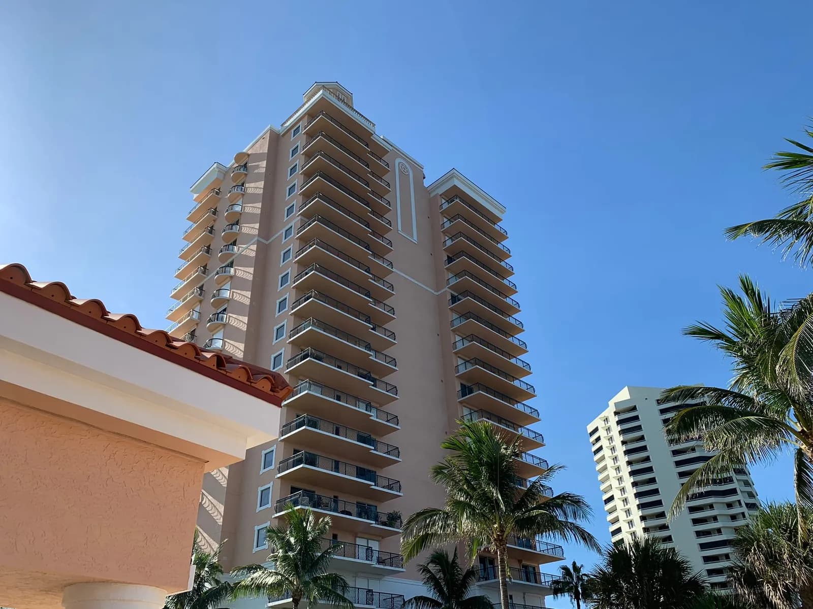 Via Delfino, a pink Mediterranean-style condominium tower on Singer Island, seen from its pool deck